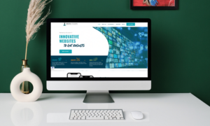 An iMac sits on a desk with the IronStride Digital Marketing homepage open on the screen.